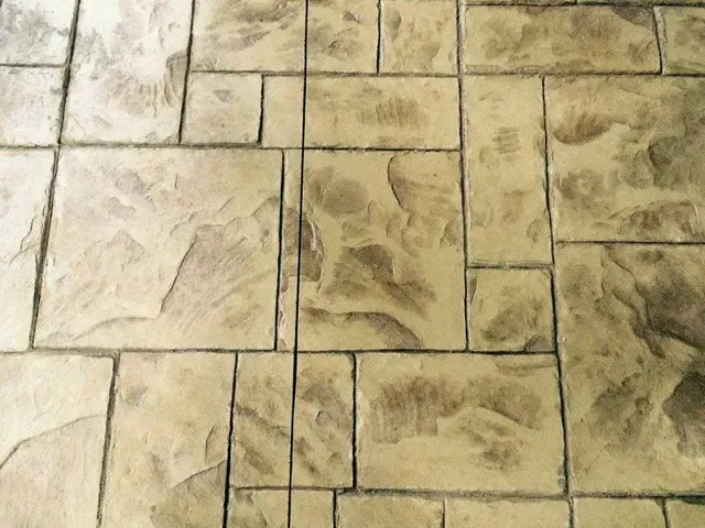 A close up of a brick floor with a pattern on it.