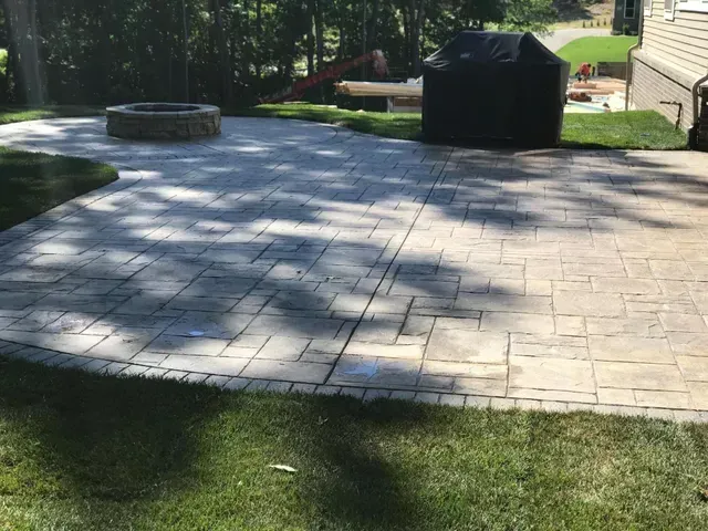 There is a fire pit in the middle of the patio.