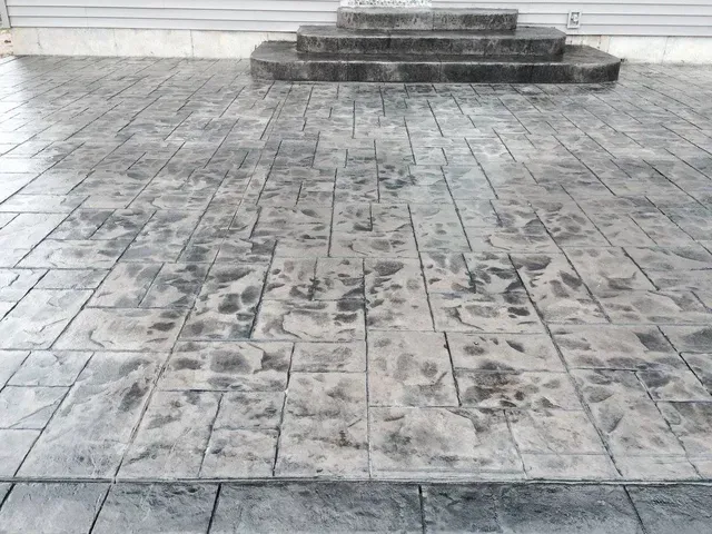 A black and white photo of a concrete driveway with steps.