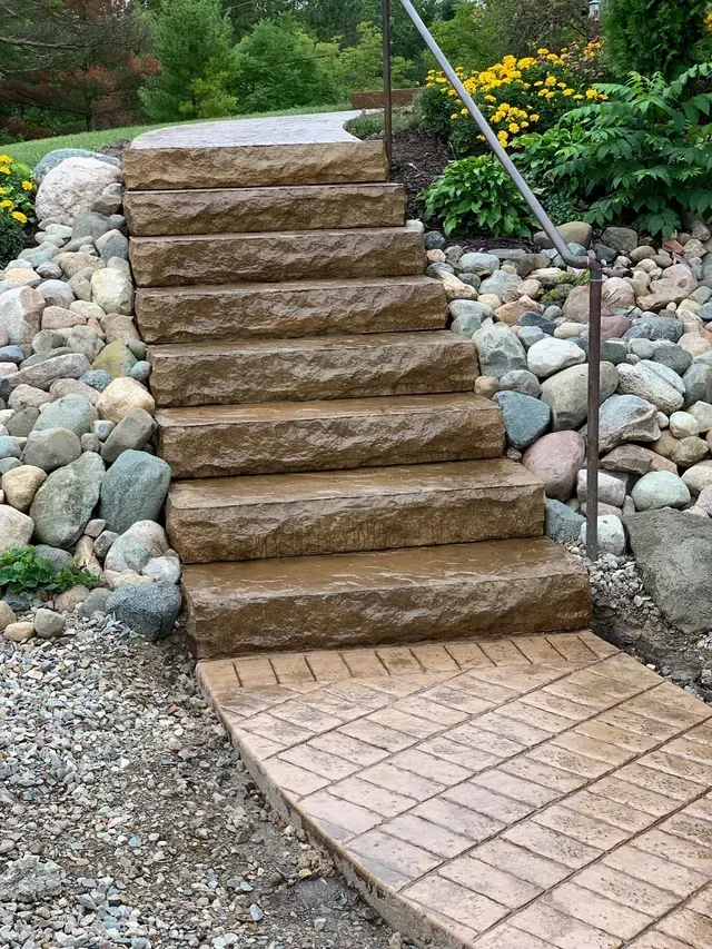 A set of stone stairs leading up to a rocky area