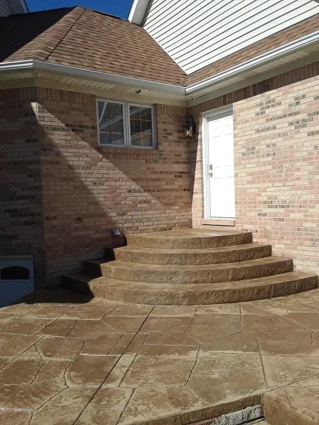A set of stairs leading up to a brick house.