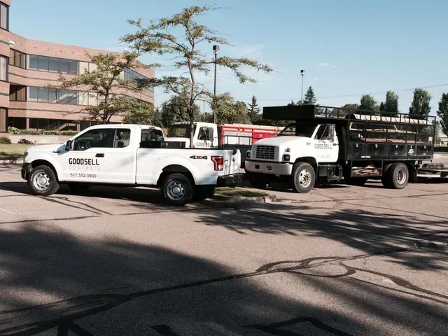 Two trucks are parked next to each other in a parking lot