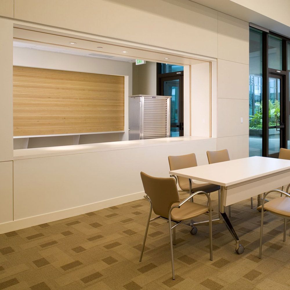 A room with a table and chairs and a window