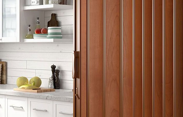 A kitchen with a wooden sliding door 
