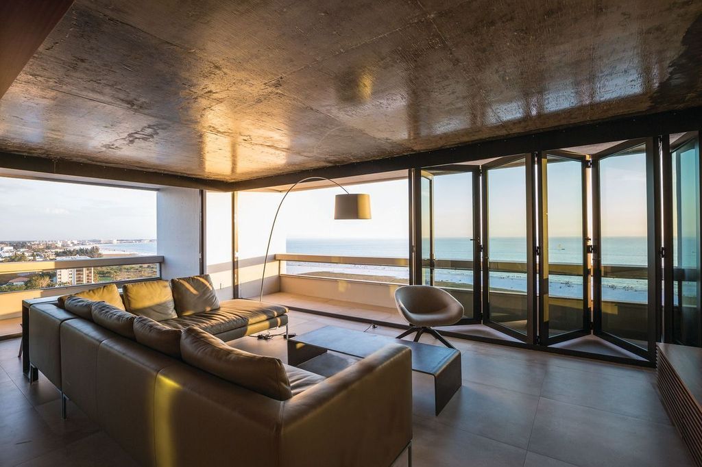 A living room with a view of the ocean