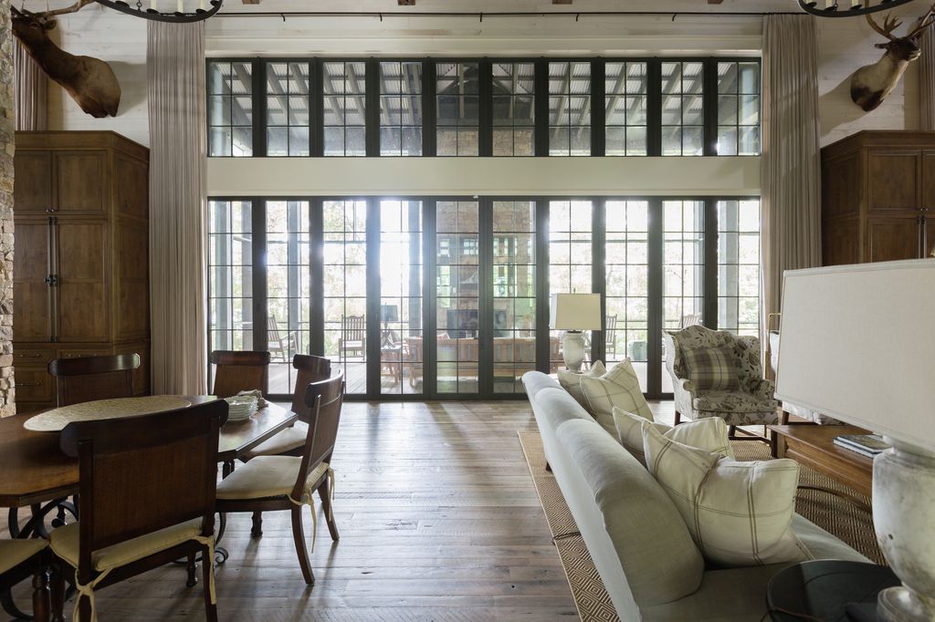 A living room with a couch, table, and chairs