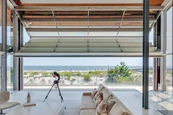 A living room with a couch and a view of the ocean