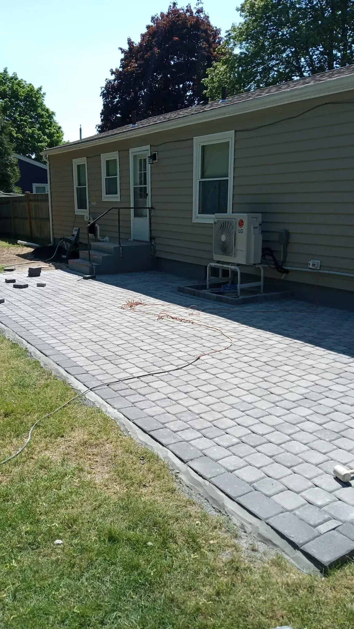 A house with a brick walkway leading to it.