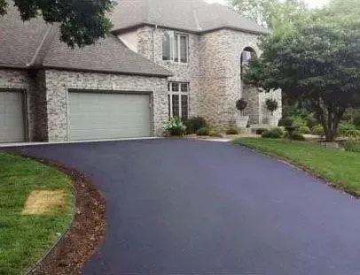 A large brick house with a driveway leading to it.