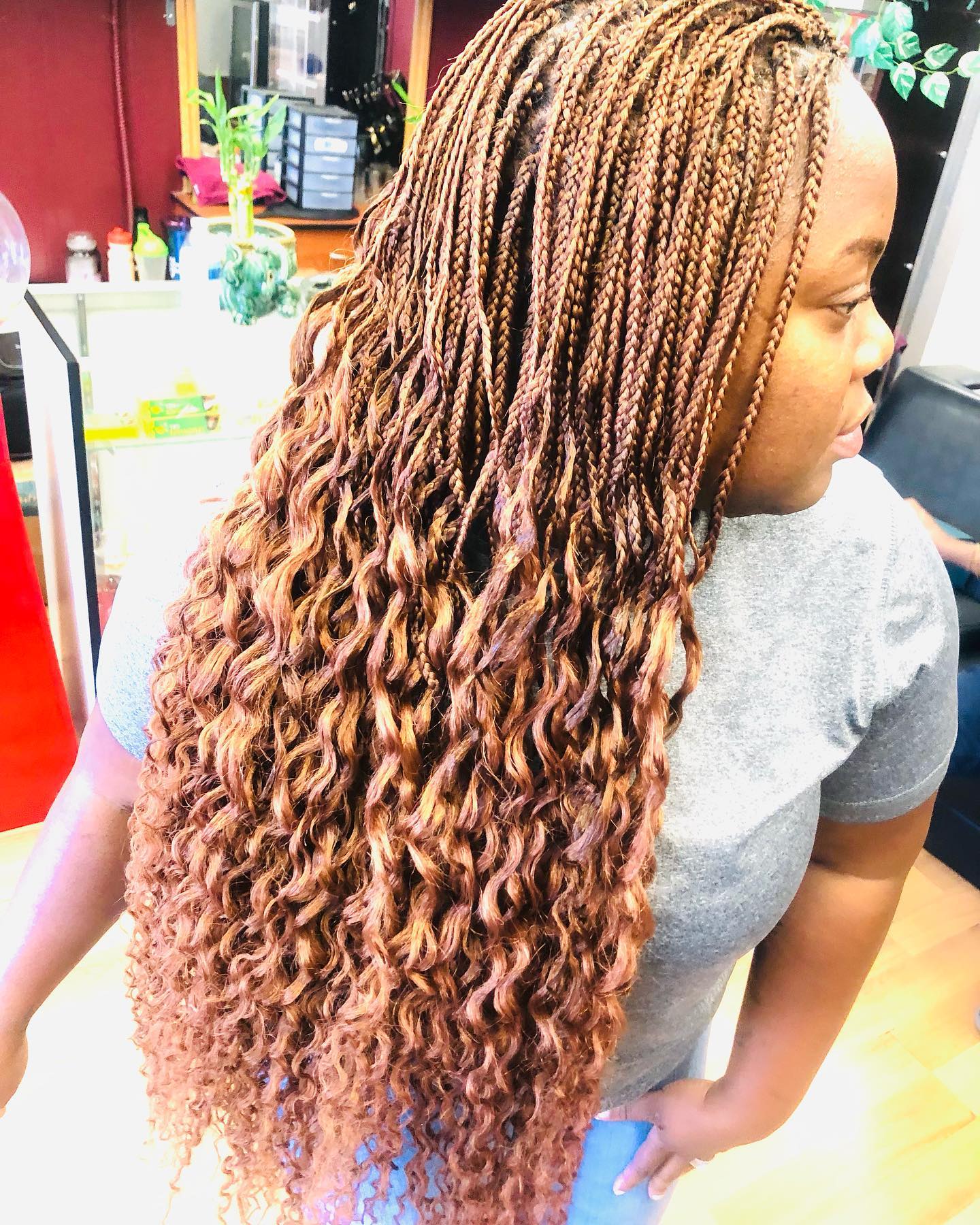 Side view of African American woman with black straight hair and bangs.