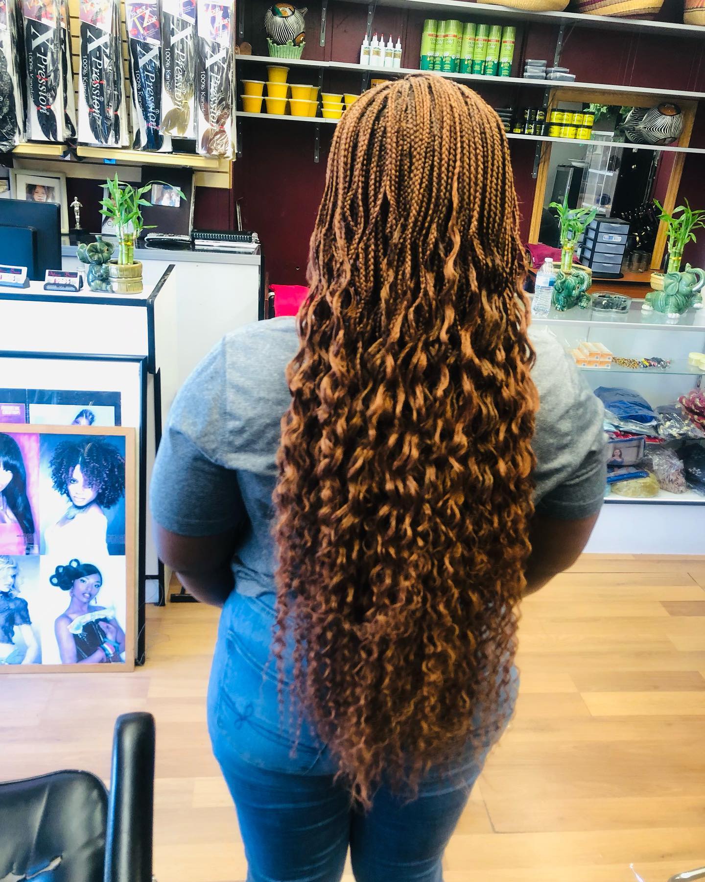 African American woman with back to camera and long light brown extensions.