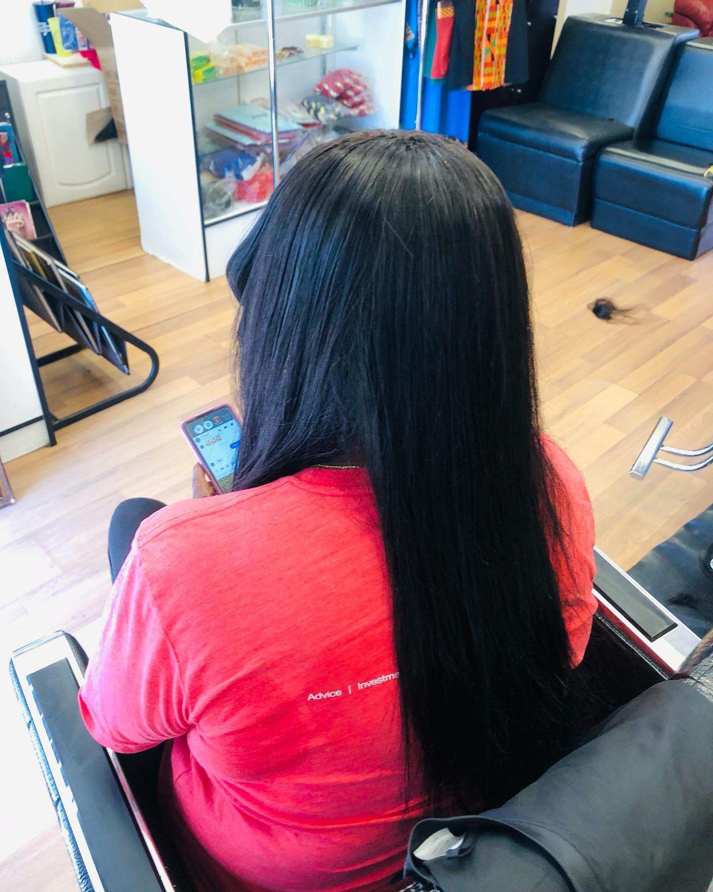 Rear view of African American woman with black straight hair and bangs.