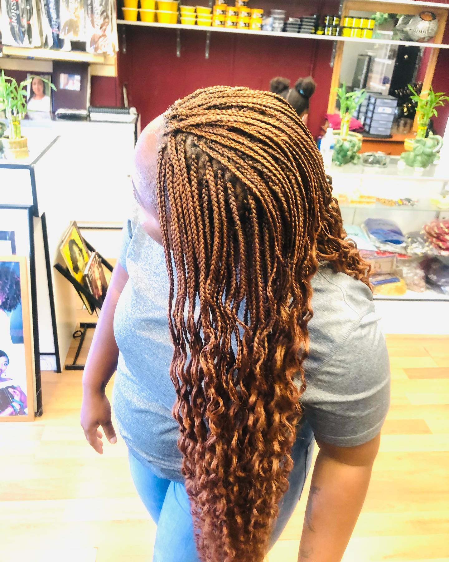 Opposite side view of African American woman with black straight hair and bangs.