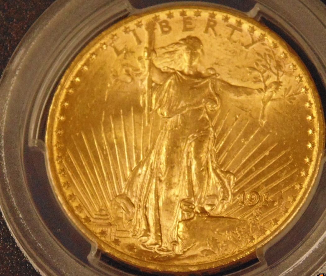 Gold coin with Lady Liberty holding a torch and olive branch, surrounded by rays.