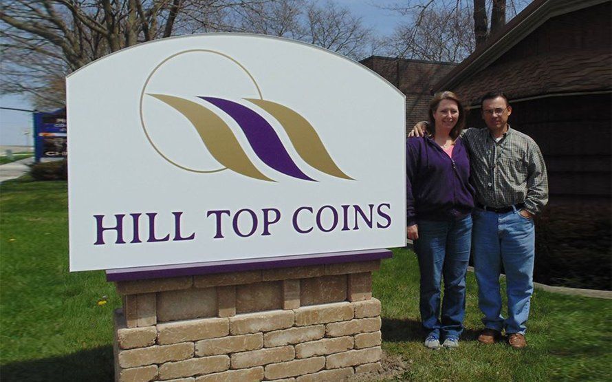 Wooden treasure chest overflowing with gold and silver coins.