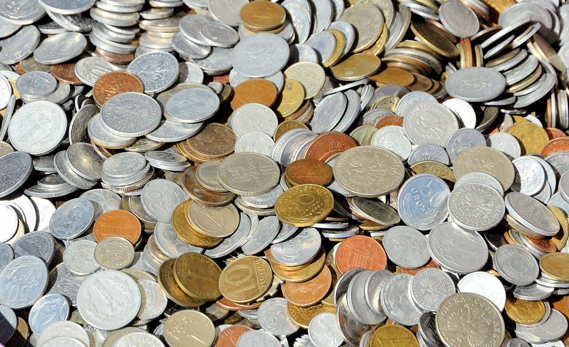 Pile of mixed coins in various colors.