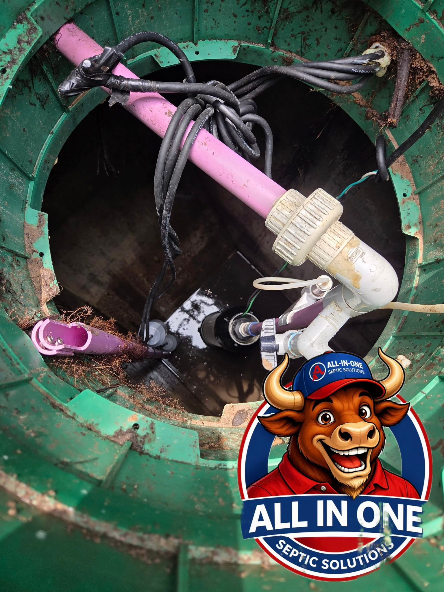 Open manhole with a pink hose, tangled cables, and a bull logo sticker at the bottom.