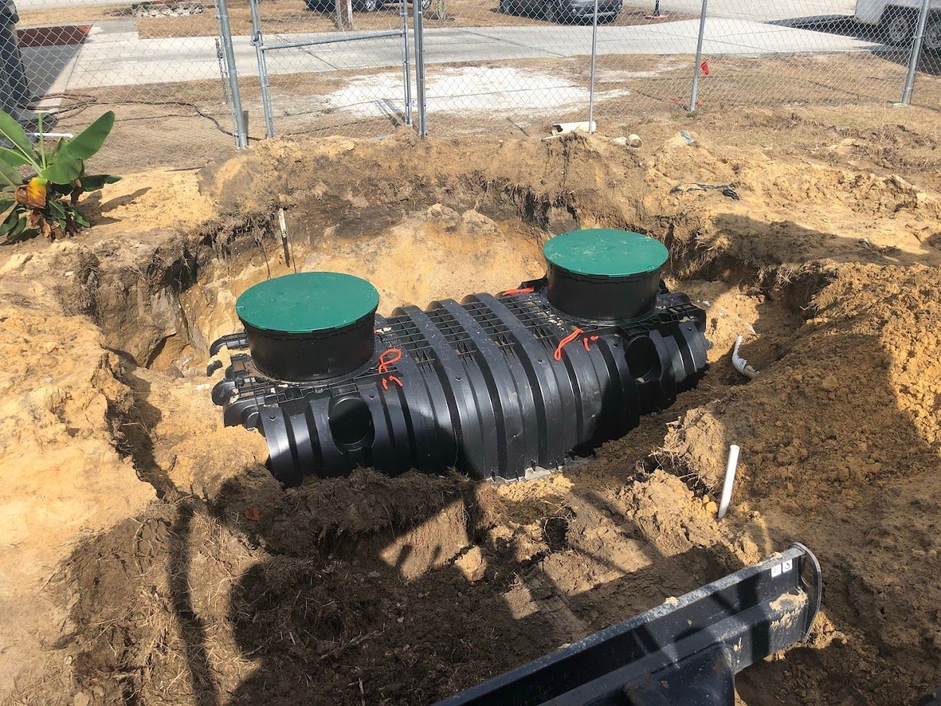 A septic tank is being installed in a hole in the ground.