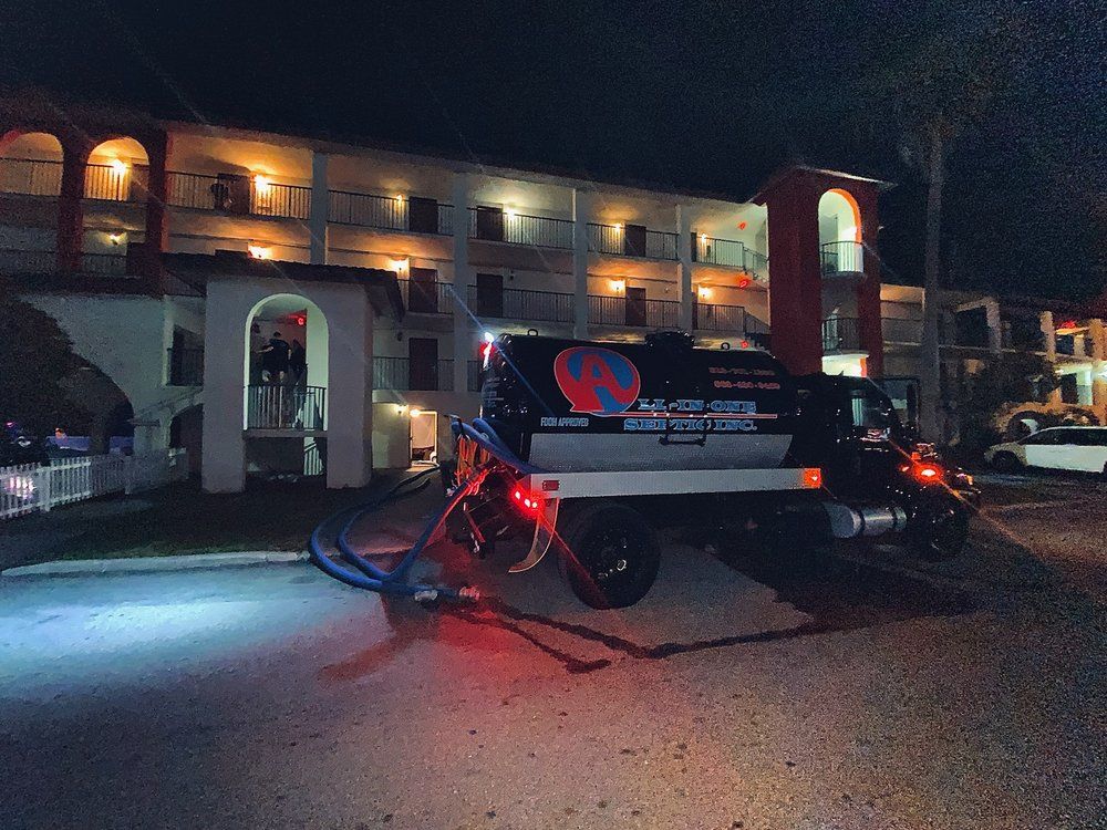 A truck is parked in front of a building at night.