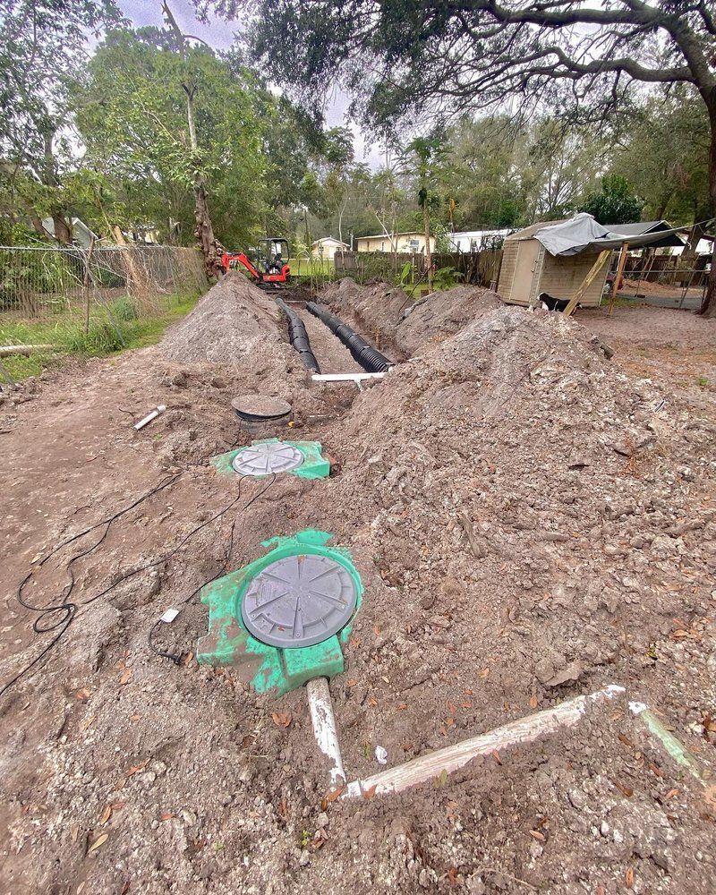 A septic system is being installed in a backyard.
