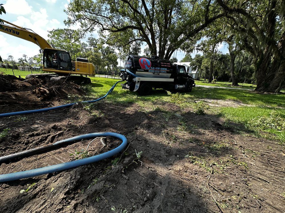 A truck with a hose attached to it is being filled with water.