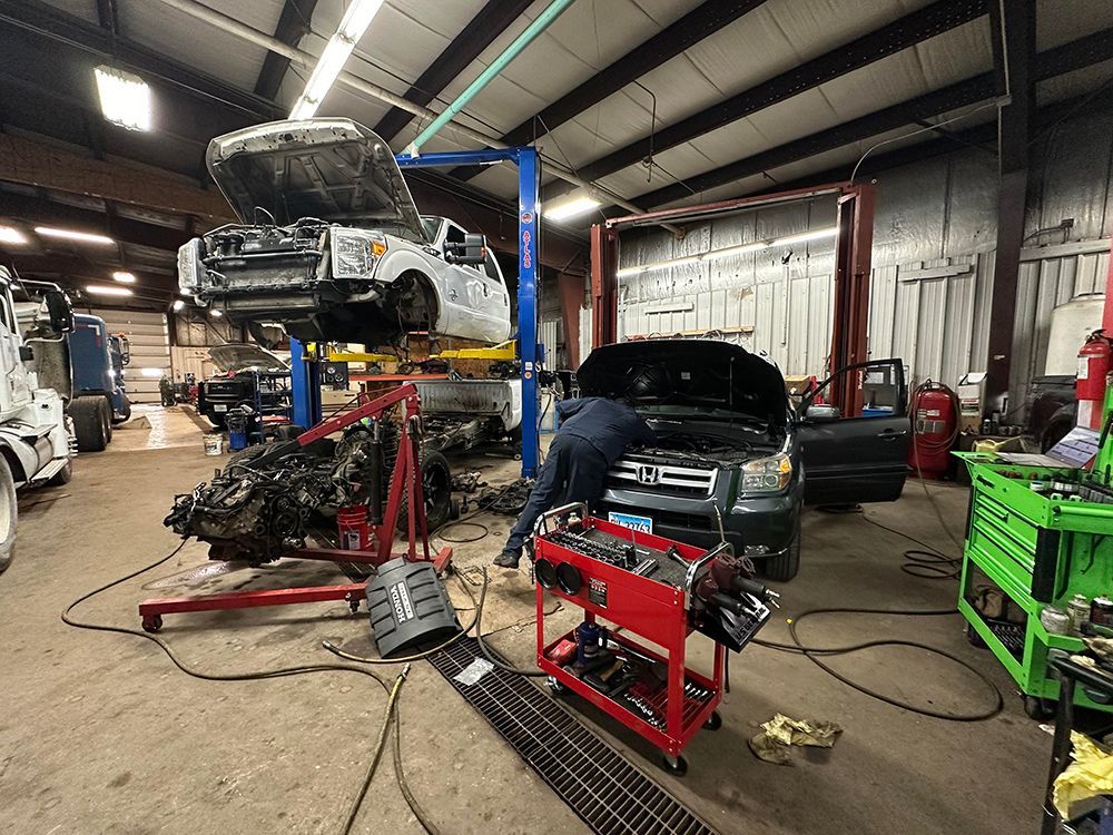 A man is working on a car in a garage