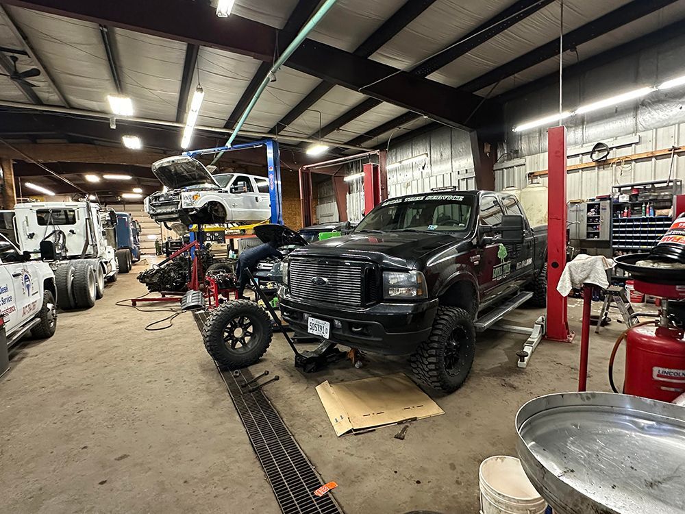 A truck is being worked on in a garage.