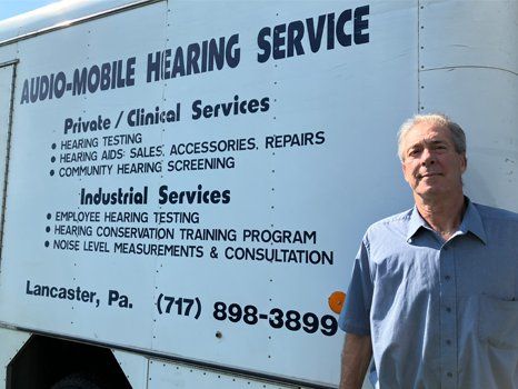 John Lusaitis in front of his mobile service vehicle