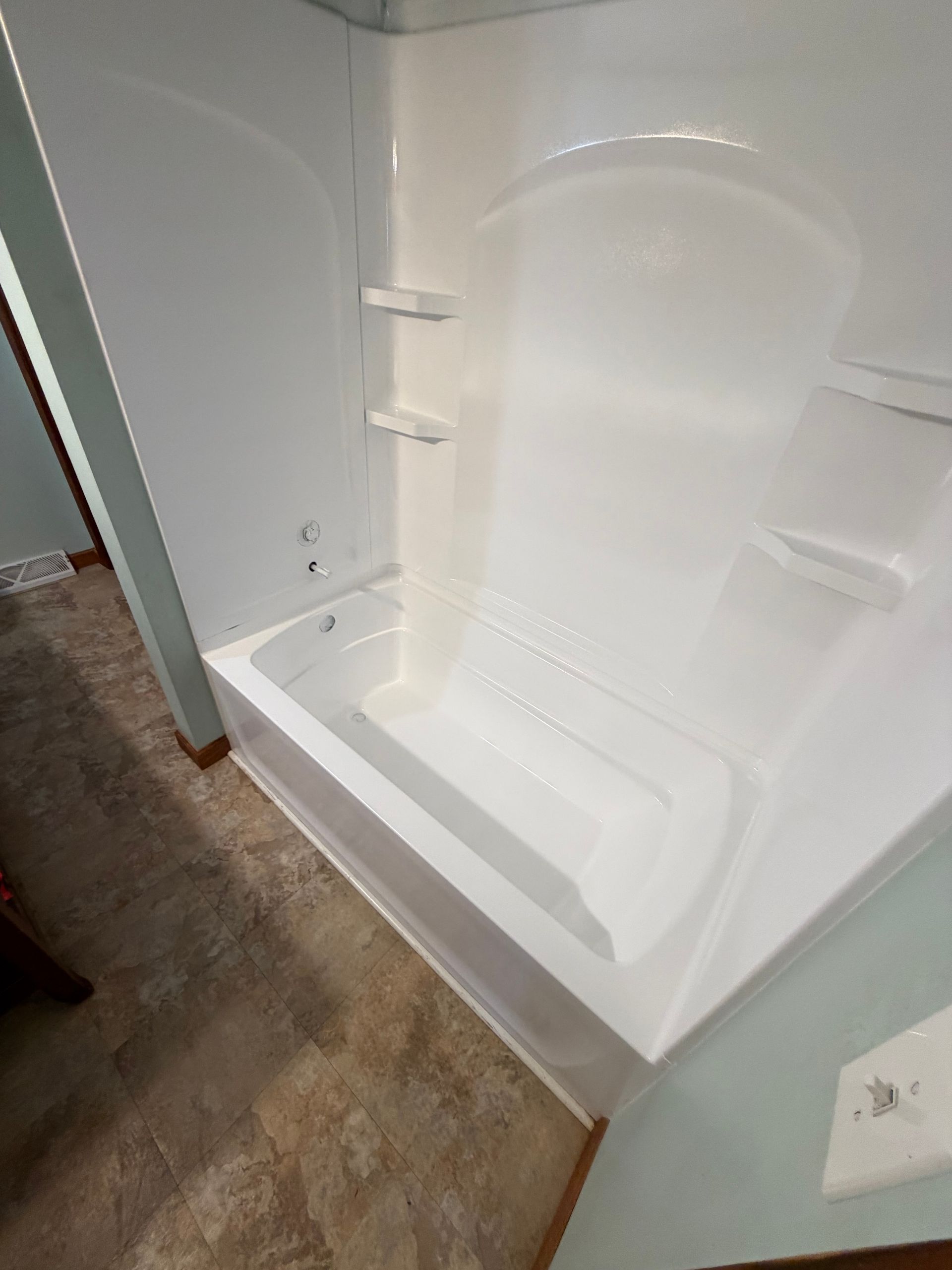 Open, empty white refrigerator interior with shelves and door bins visible