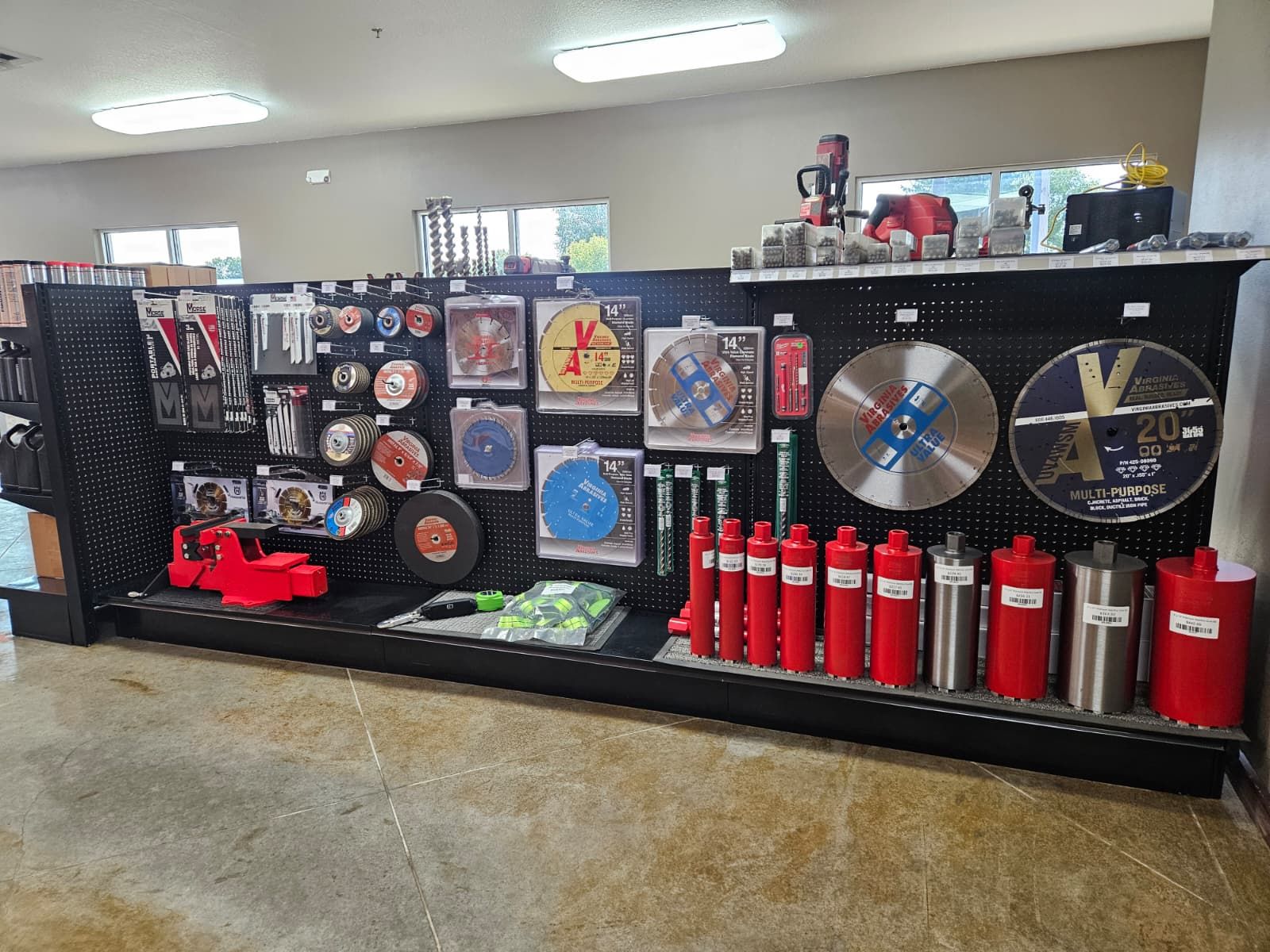 Display of various cutting tools, including saw blades, on a store shelf.