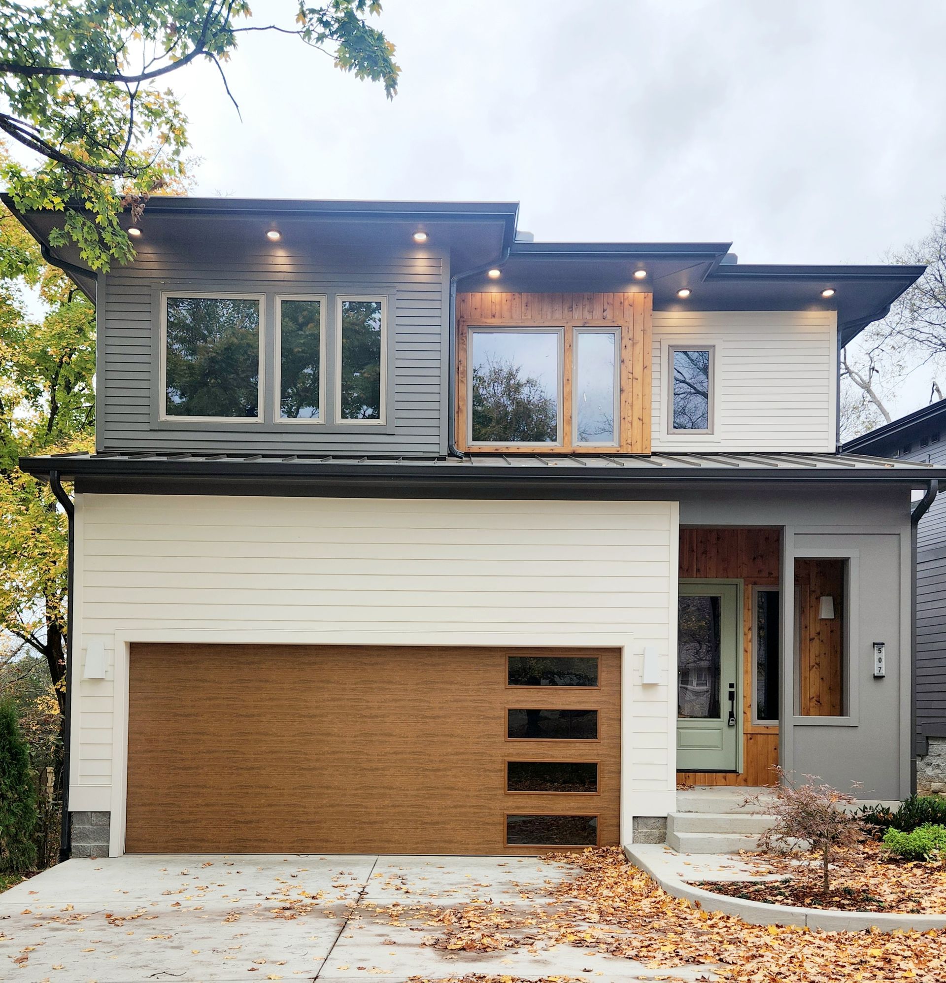 The front of a house with a wooden garage door