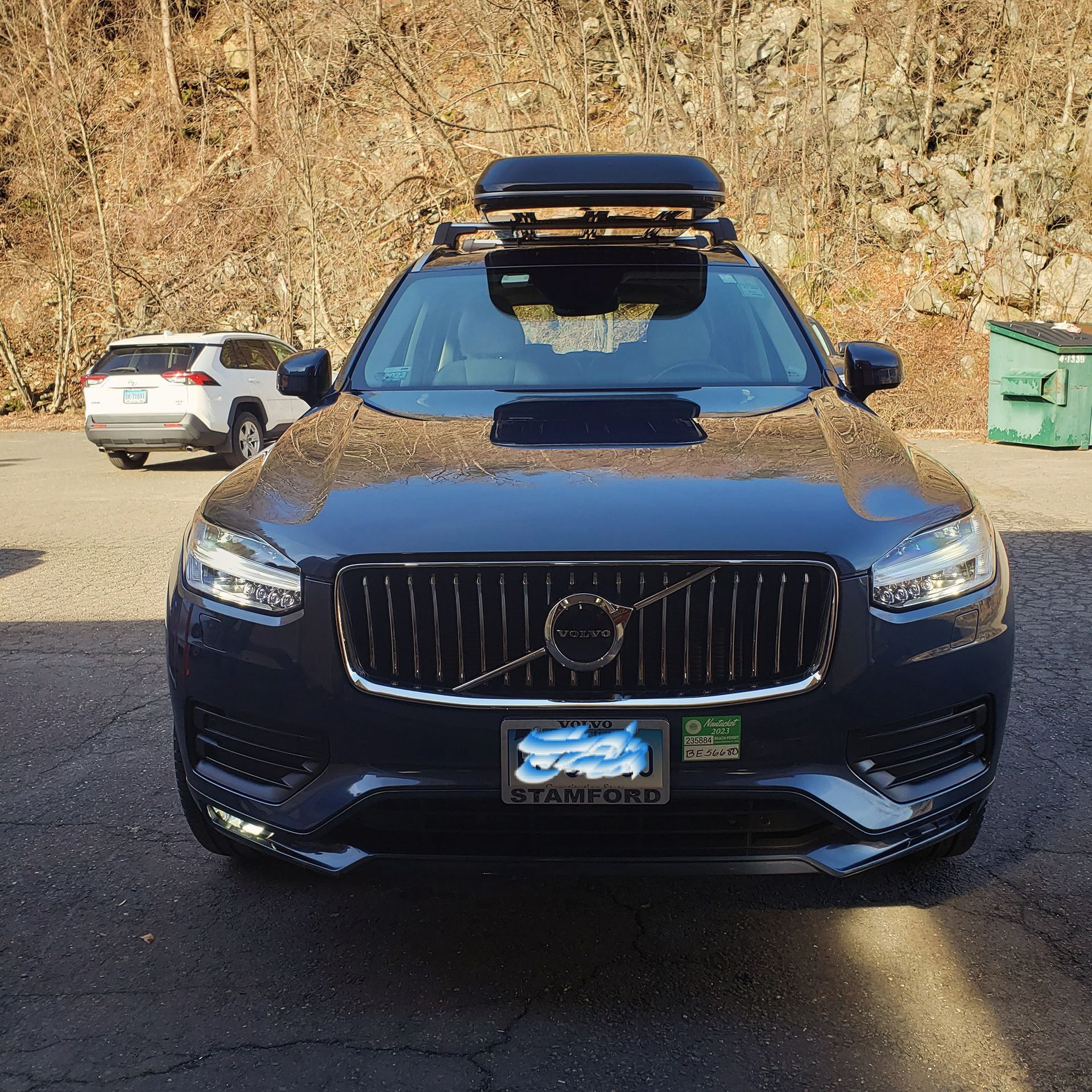A black volvo with a roof rack on top of it