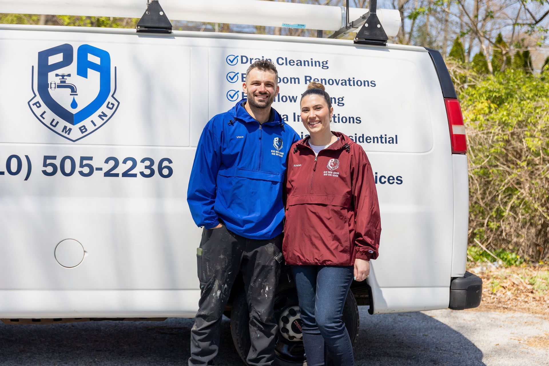 Two people standing in front of a white cleaning service van with a company logo.