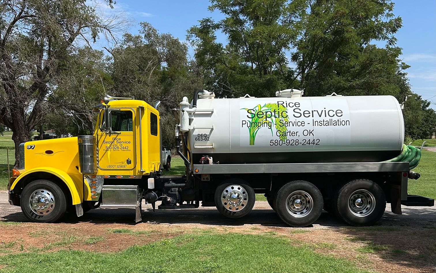 Yellow septic service truck parked outdoors.