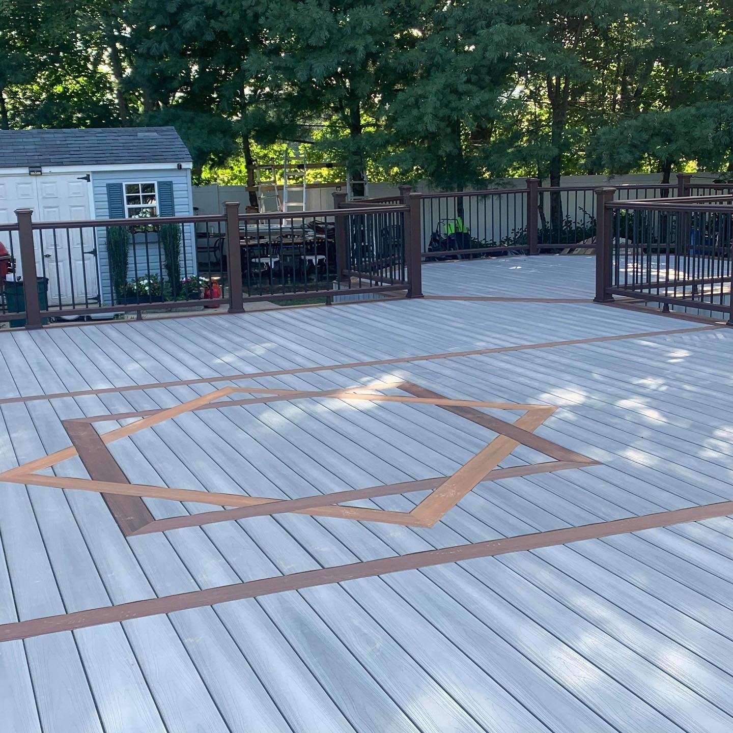 A wooden deck with a geometric design on it.
