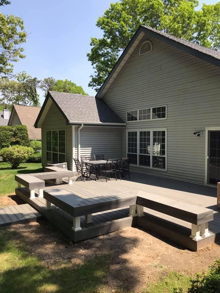 A house with a large deck and a table and chairs on it