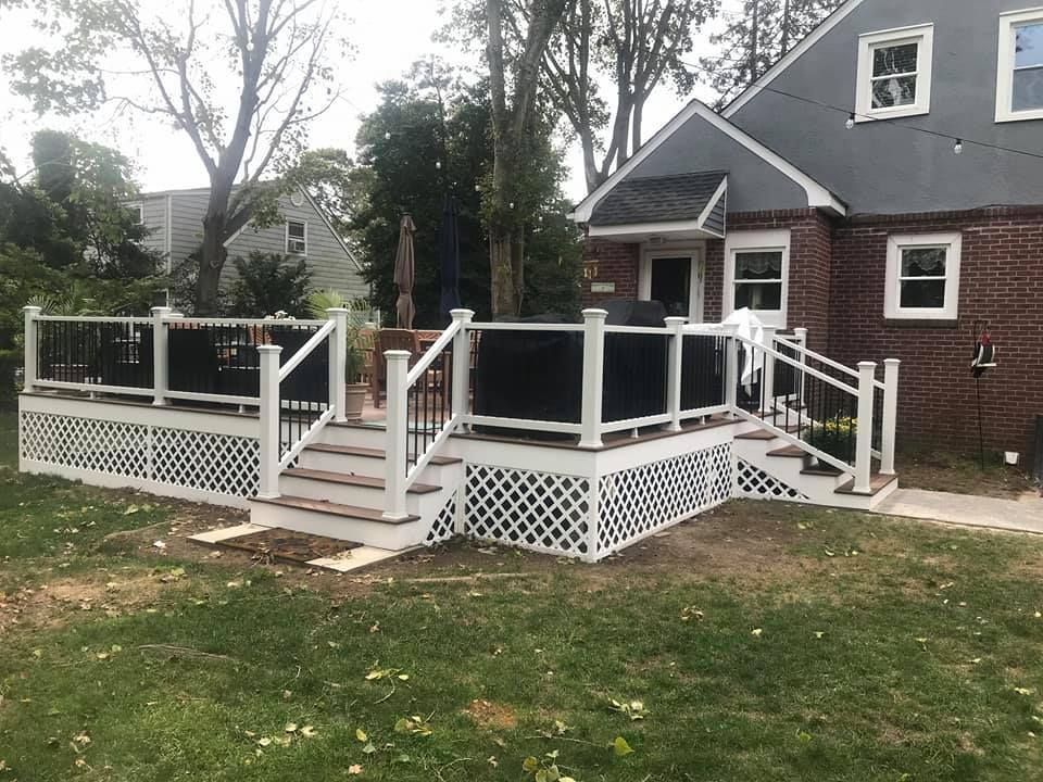 A house with a large deck and a table and chairs on it