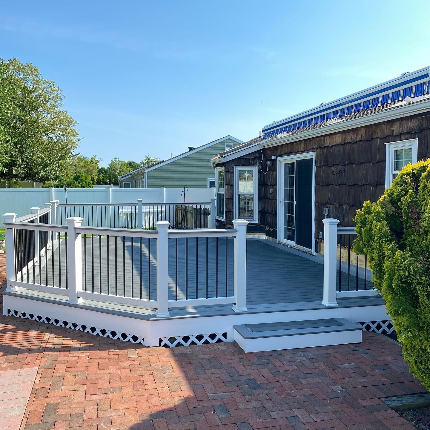 A house with a large deck and a white railing.