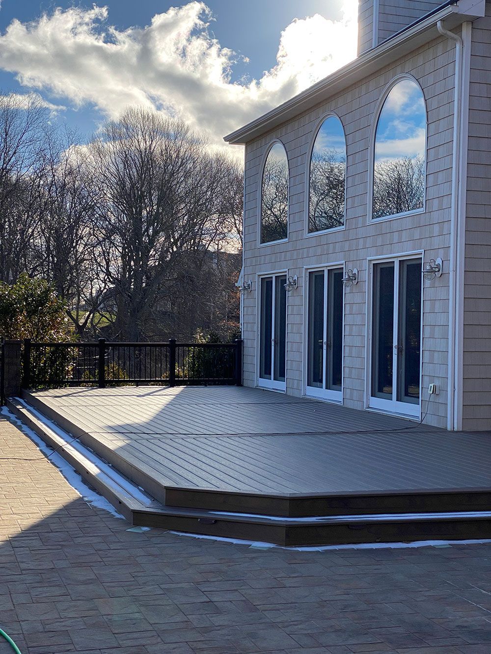 A large house with a large deck in front of it.