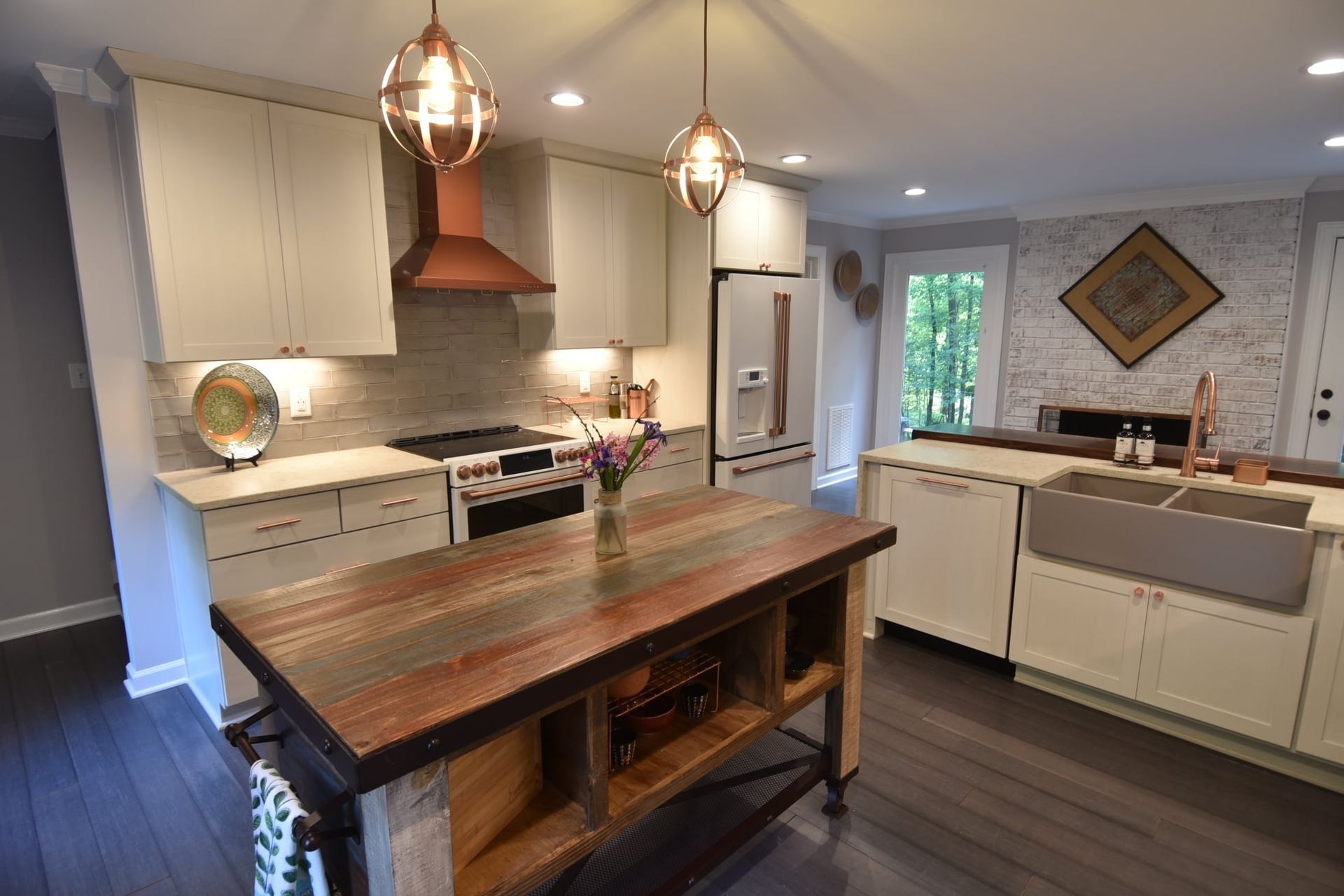 A kitchen with a large wooden island in the middle.