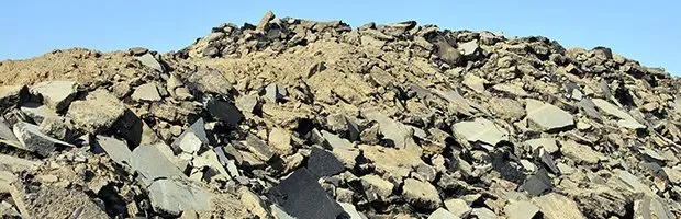 A large pile of rocks is sitting on top of a hill.