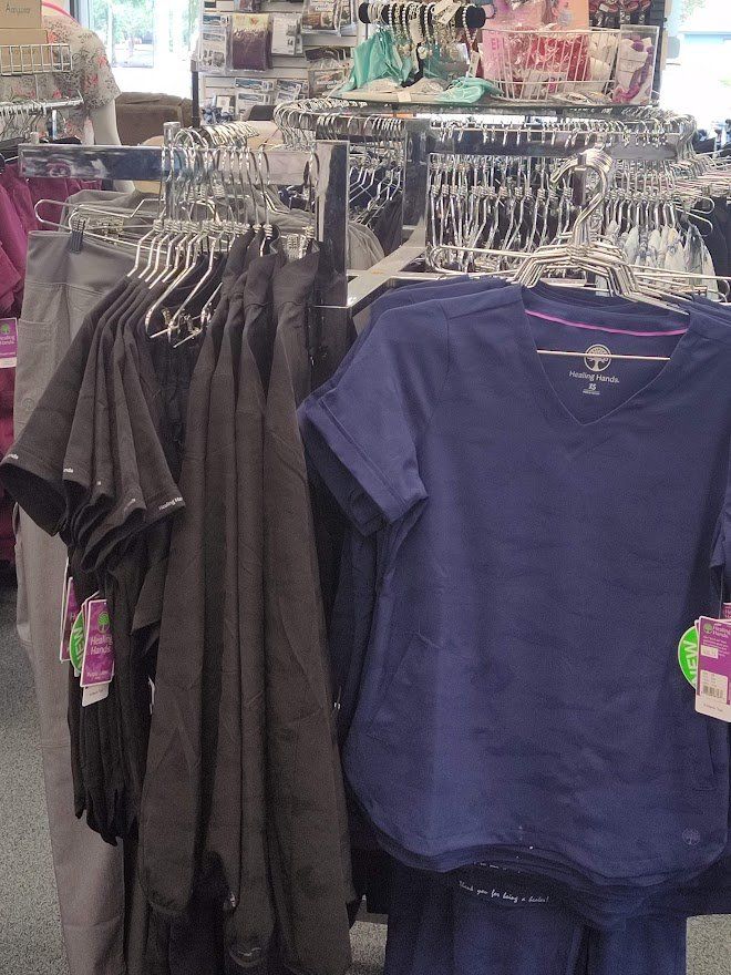 Clothes rack with black and blue shirts in a store.