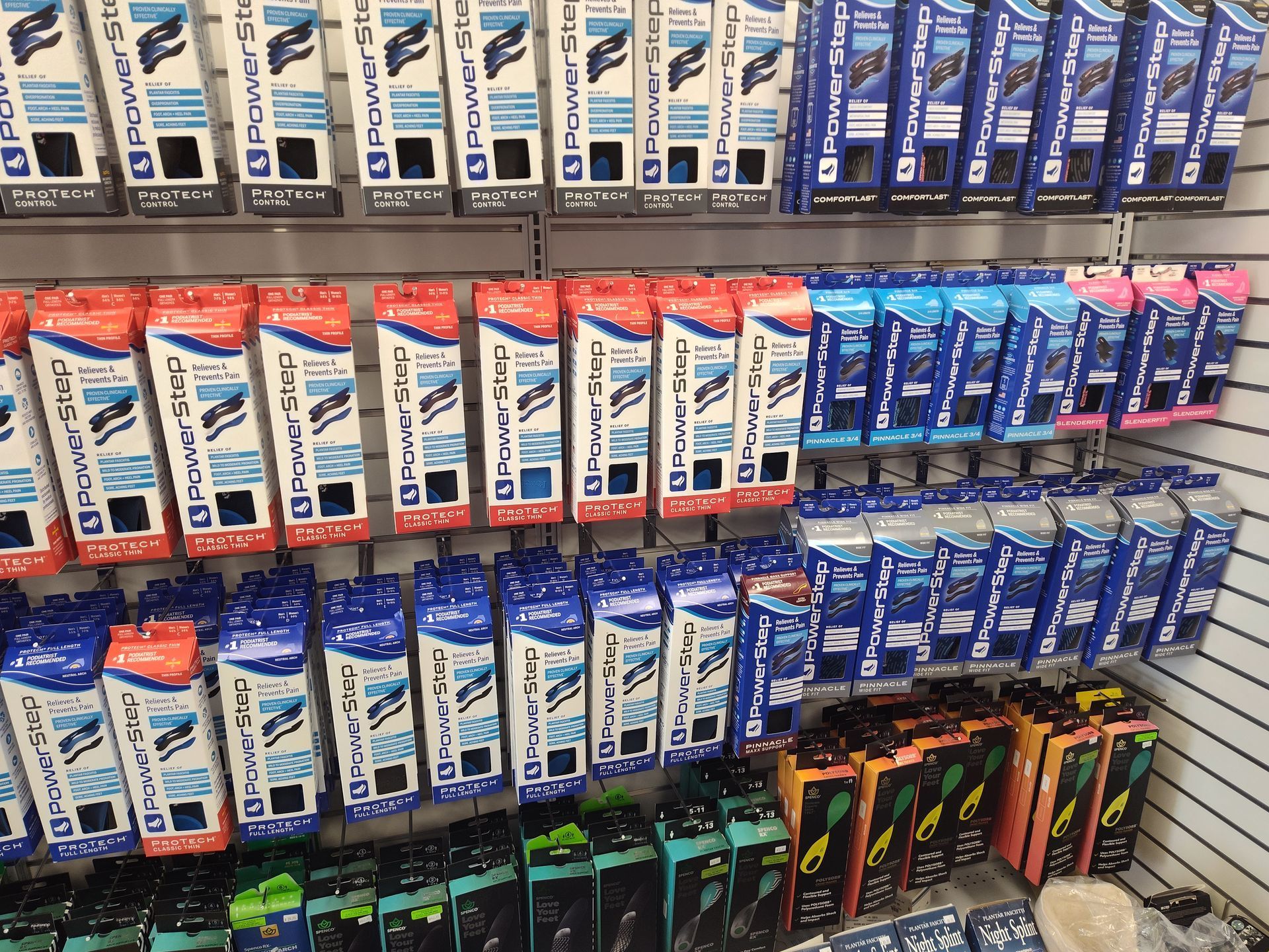 Shelves stocked with packaged power tools in various colors.