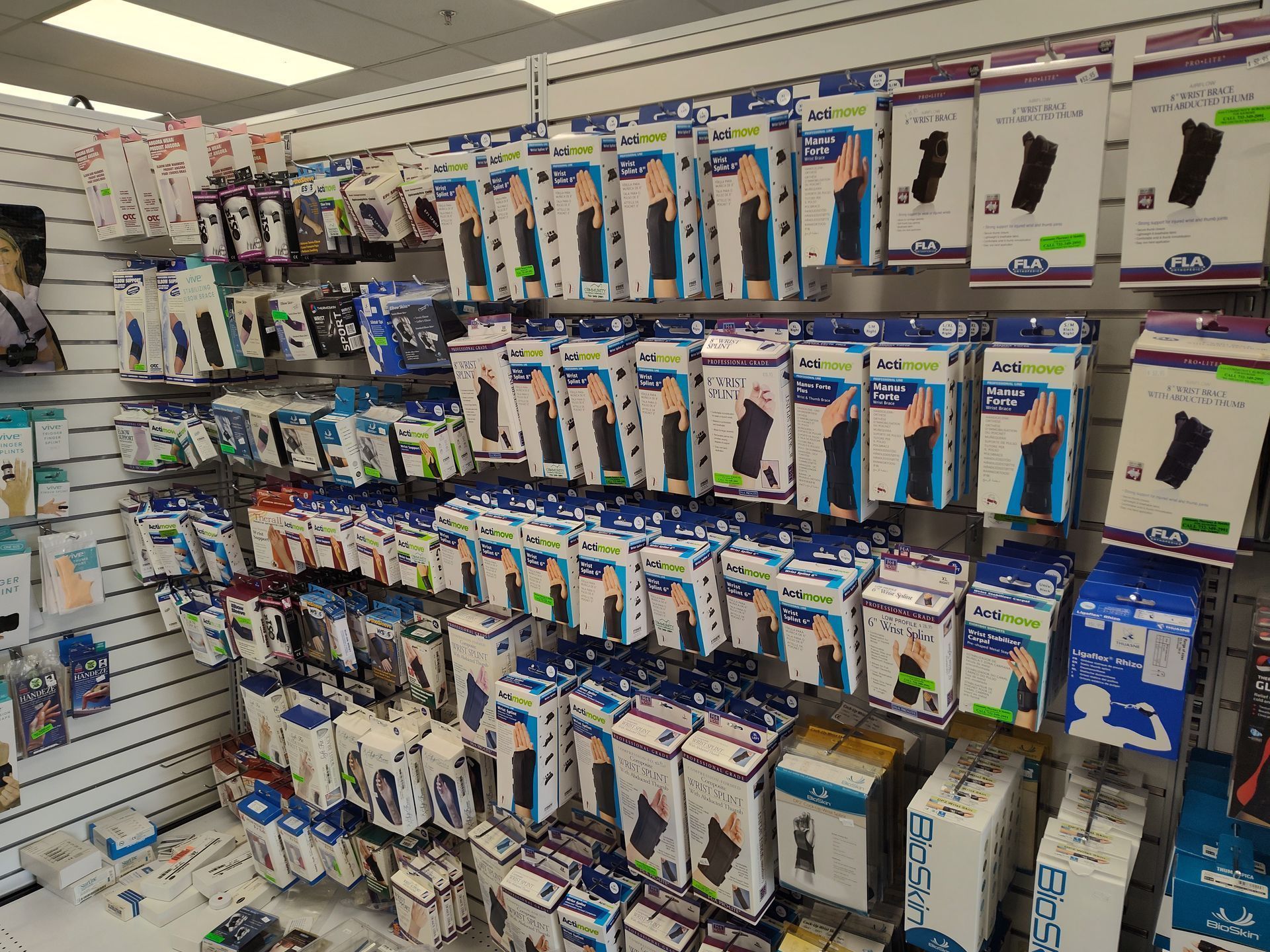 Shelves stocked with orthopedic support braces and related medical supplies in a retail setting.