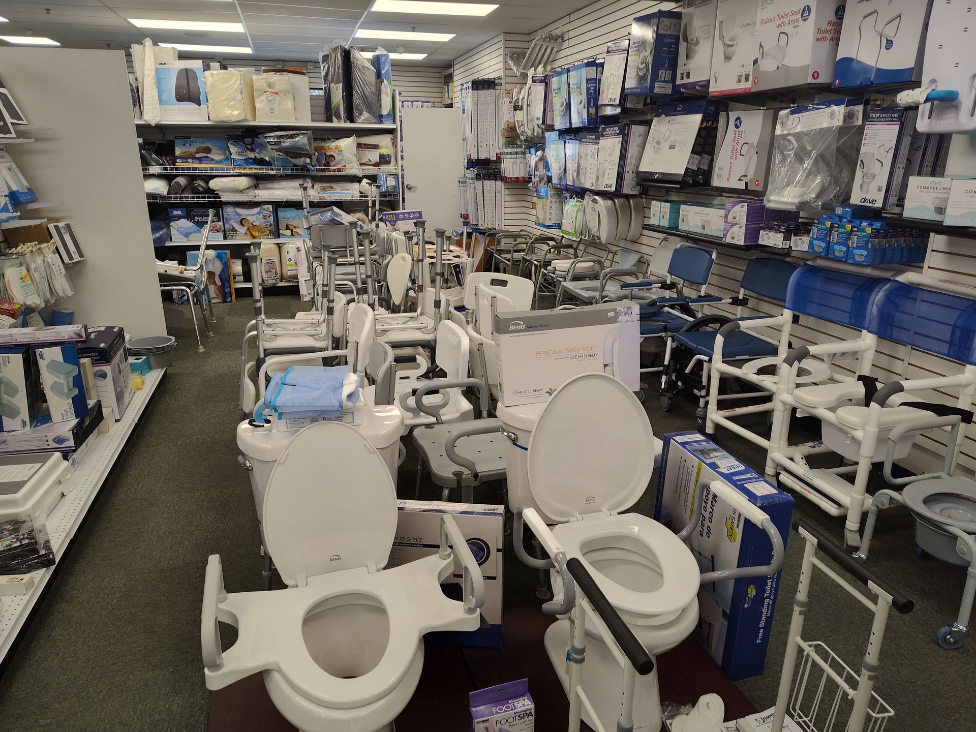 Medical supply store aisle with raised toilet seats, and other mobility aids.