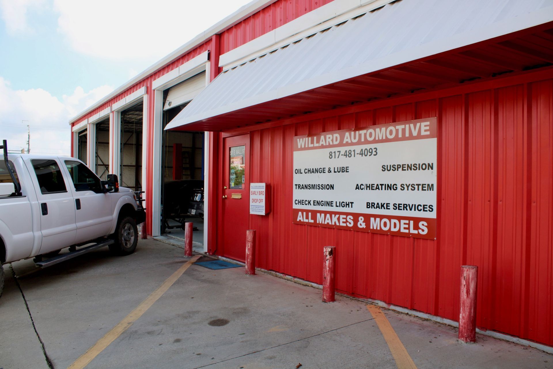 Willard Automotive technician performing a vehicle belt replacement in Grapevine, TX.