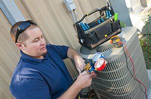 repairman examining the Heating and AC unit in macungie