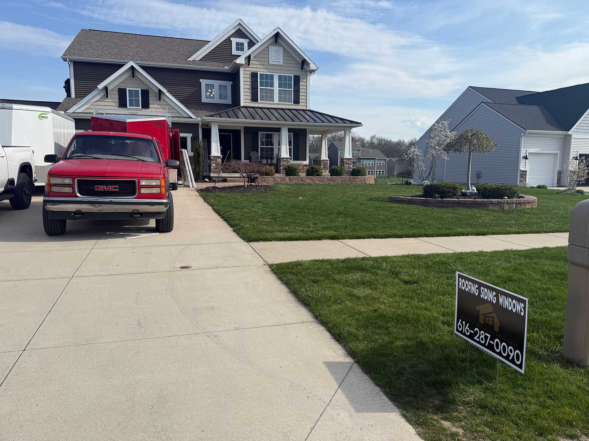 a red truck is parked in front of a large house