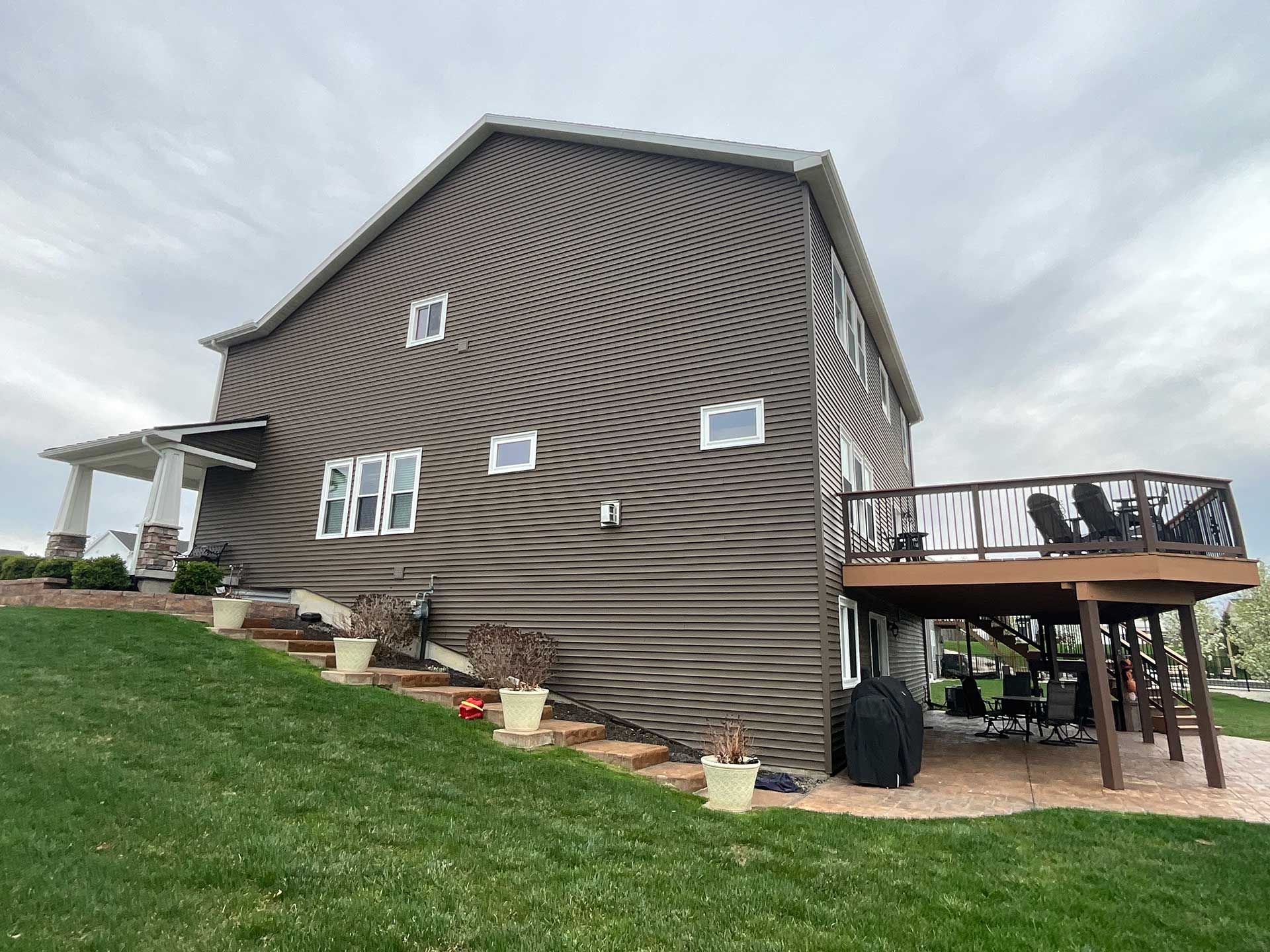 a large house with a deck and stairs on the side of it