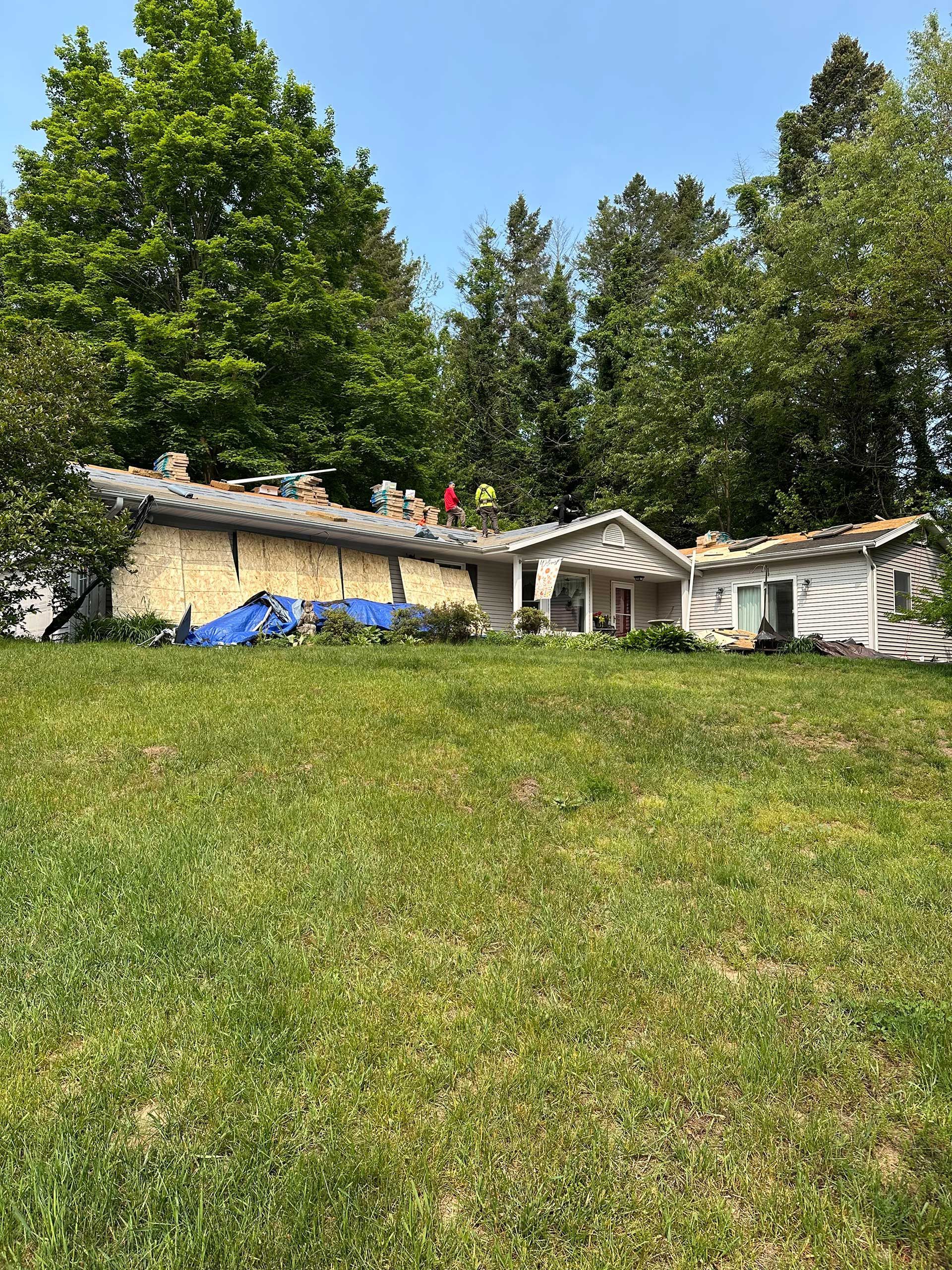 a house is sitting in the middle of a grassy field